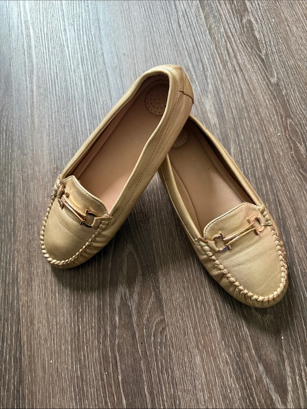 Women gold faux leather moccasin loafers featuring a rounded toe, light